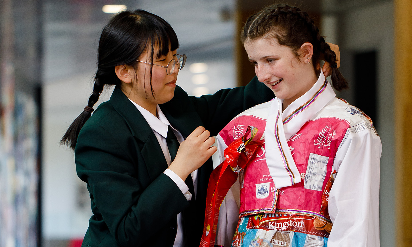 Marsden 14-9 031-2-Minkyung adjusts hanbok on Amy-4web.jpg